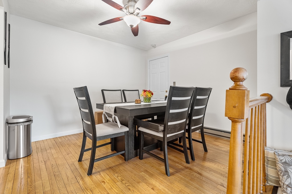 6 Erick Road, Unit 75 Mansfield, MA 02048 - Photo 5 of 20 a view of a dining room with furniture and wooden floor