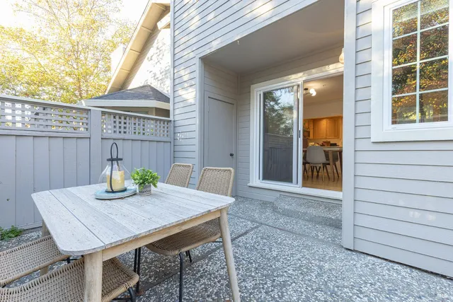 a view of a big house with a big yard and large trees