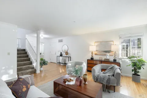 a living room with furniture and wooden floor