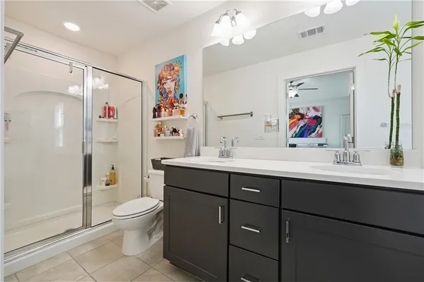 a bathroom with a sink a large mirror and a bathtub