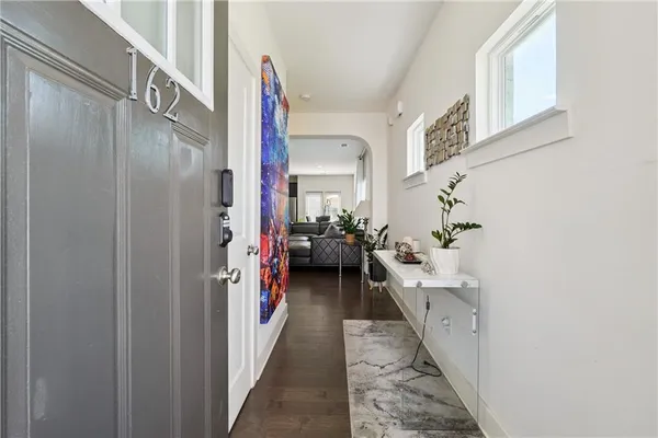 a view of a hallway with a livingroom and a stairs
