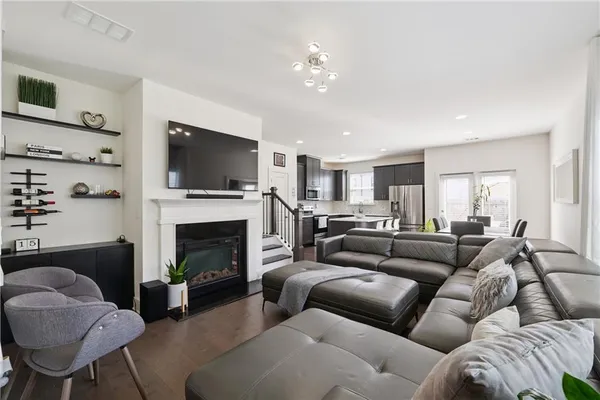 a living room with furniture a fireplace and a flat screen tv