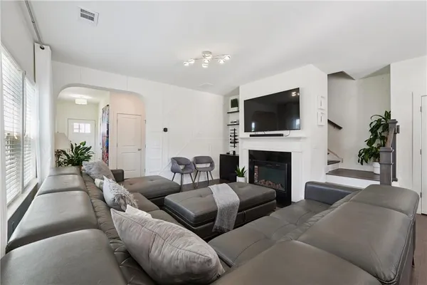 a living room with furniture a fireplace and a flat screen tv