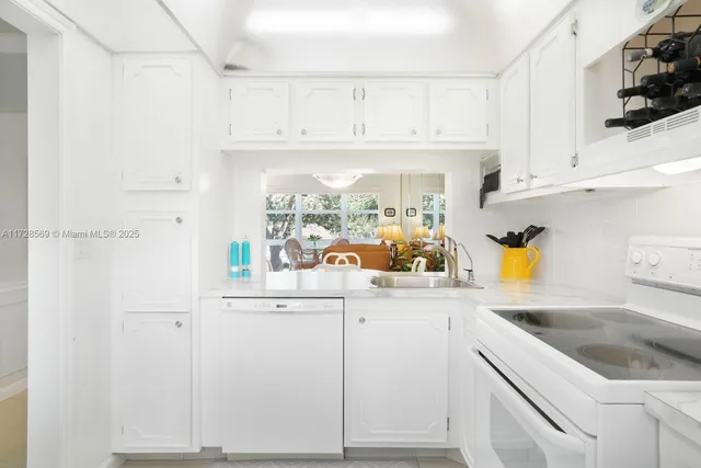 a kitchen with stainless steel appliances granite countertop a sink and cabinets