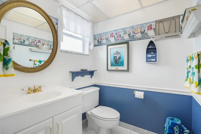 a bathroom with a toilet a sink and a mirror