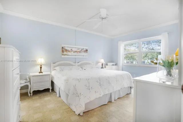 a bedroom with a bed table and window