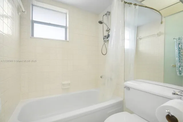 a bathroom with a toilet and a bathtub