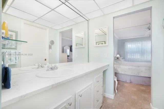 a bathroom with a sink vanity granite tub shower and a mirror