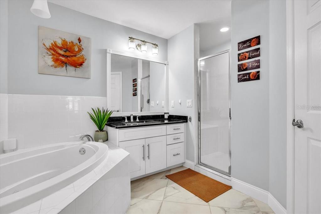 1260 Rio De Janeiro Avenue, Unit 102 Punta Gorda, FL 33983 - Photo 26 of 46 a bathroom with a tub a sink and a shower