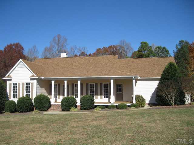 1404 G W Court Raleigh, NC 27603 - Photo 1 of 25 a front view of a house with a yard and garage