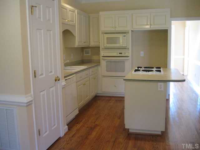 1404 G W Court Raleigh, NC 27603 - Photo 12 of 25 a kitchen with a sink stove and cabinets