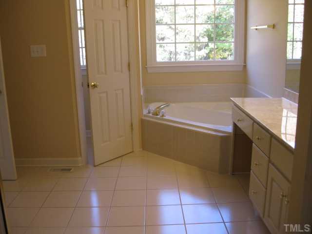 1404 G W Court Raleigh, NC 27603 - Photo 14 of 25 a bathroom with a tub shower and sink