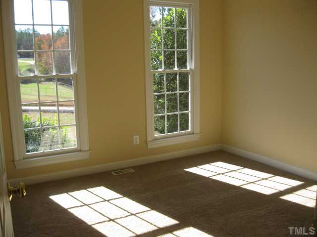 1404 G W Court Raleigh, NC 27603 - Photo 21 of 25 an empty room with wooden floor and windows