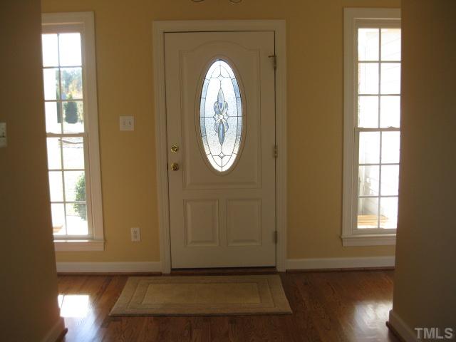 1404 G W Court Raleigh, NC 27603 - Photo 5 of 25 an empty room with wooden floor and windows