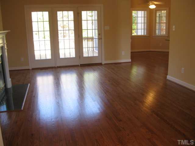 1404 G W Court Raleigh, NC 27603 - Photo 7 of 25 a view of an empty room with wooden floor and a window