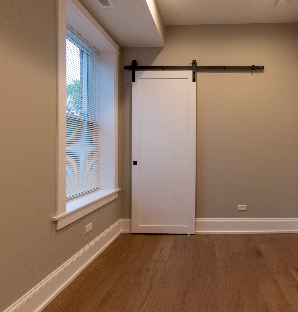 3755 West Addison Street, Unit 2E Chicago, IL 60618 - Photo 15 of 20 a view of a room with wooden floor and cabinet