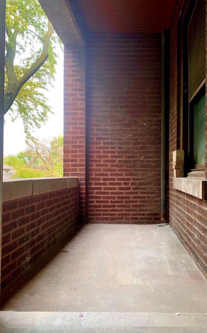 3755 West Addison Street, Unit 2E Chicago, IL 60618 - Photo 19 of 20 a view of a brick wall with an outdoor space