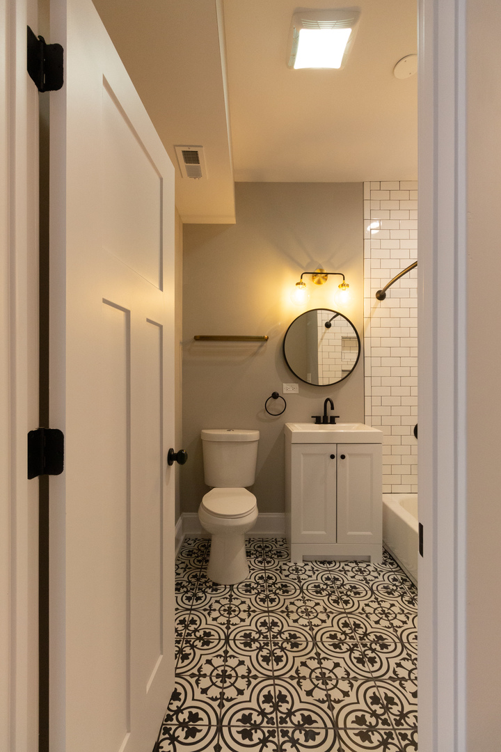 3755 West Addison Street, Unit 2E Chicago, IL 60618 - Photo 8 of 20 a bathroom with a toilet and a mirror
