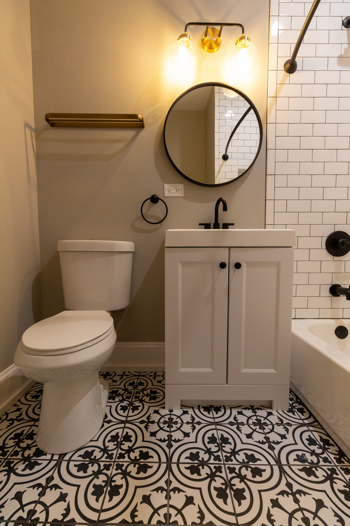 3755 West Addison Street, Unit 2E Chicago, IL 60618 - Photo 9 of 20 a bathroom with a toilet a sink and mirror