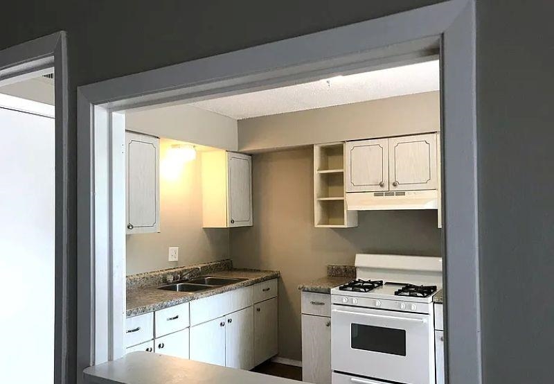 600 Patterson Street Memphis, TN 38111 - Photo 8 of 10 a kitchen with granite countertop a stove and a wooden floor