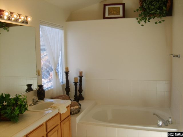 724 Silver Mine Court Reno, NV 89521 - Photo 6 of 9 a bathroom with a tub sink and mirror