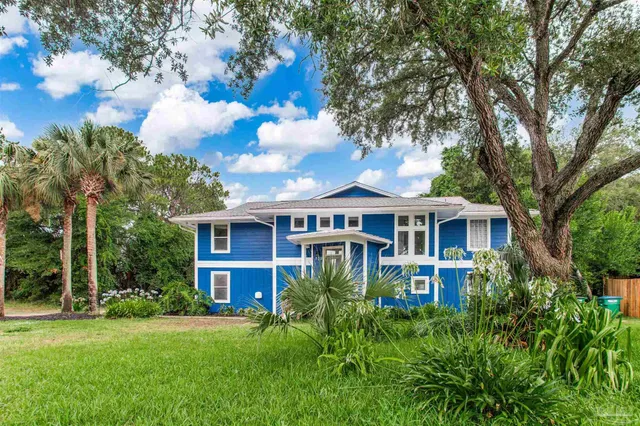a front view of a house with a garden