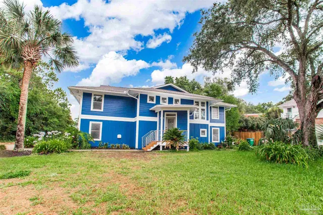 a front view of a house with a yard table and chairs