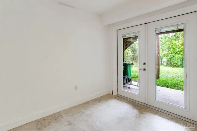 an empty room with windows and entrance