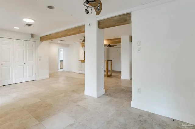 a spacious bathroom with a granite countertop sink a mirror a toilet and a shower