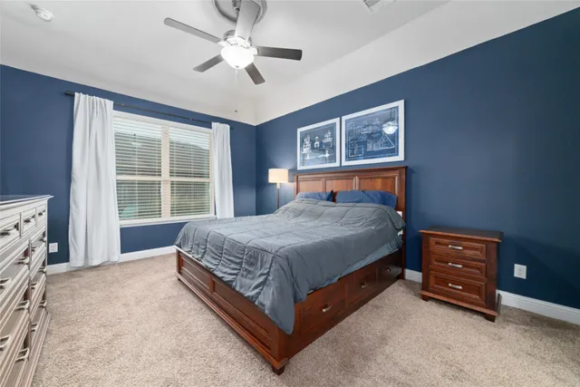 a bedroom with a bed dresser and a window