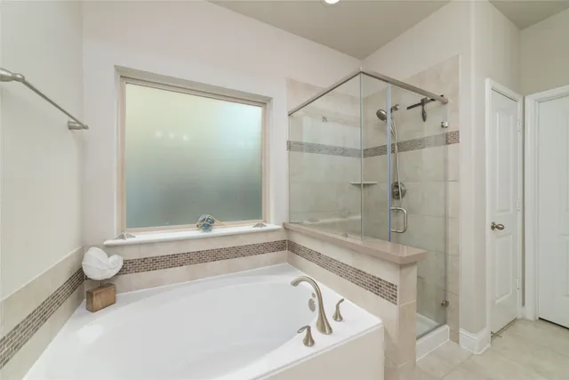 a bathroom with a bathtub and a shower