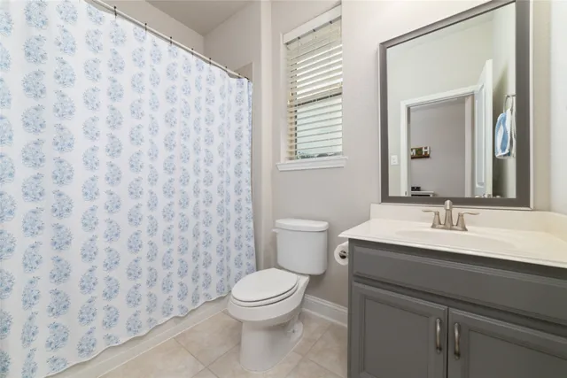 a bathroom with a toilet a sink and a mirror