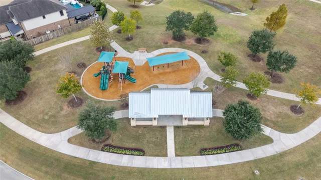an aerial view of a house with swimming pool and patio