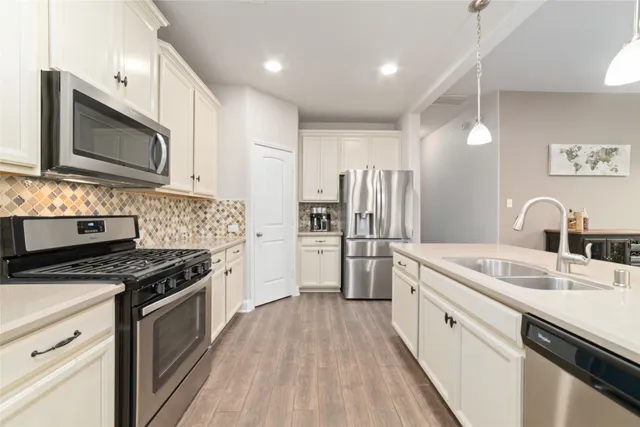 a kitchen with a sink stove and microwave