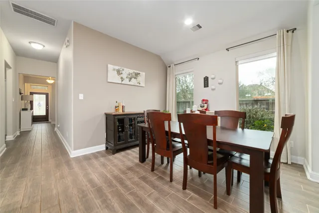 a view of a dining room with furniture window and wooden floor