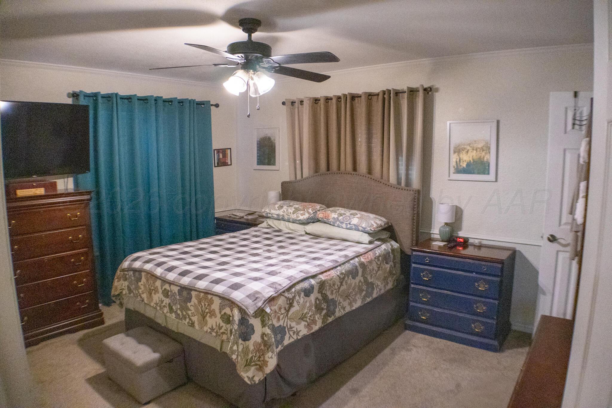 4504 Goodnight Trail Amarillo, TX 79109 - Photo 15 of 32 a bedroom with a bed and a dresser