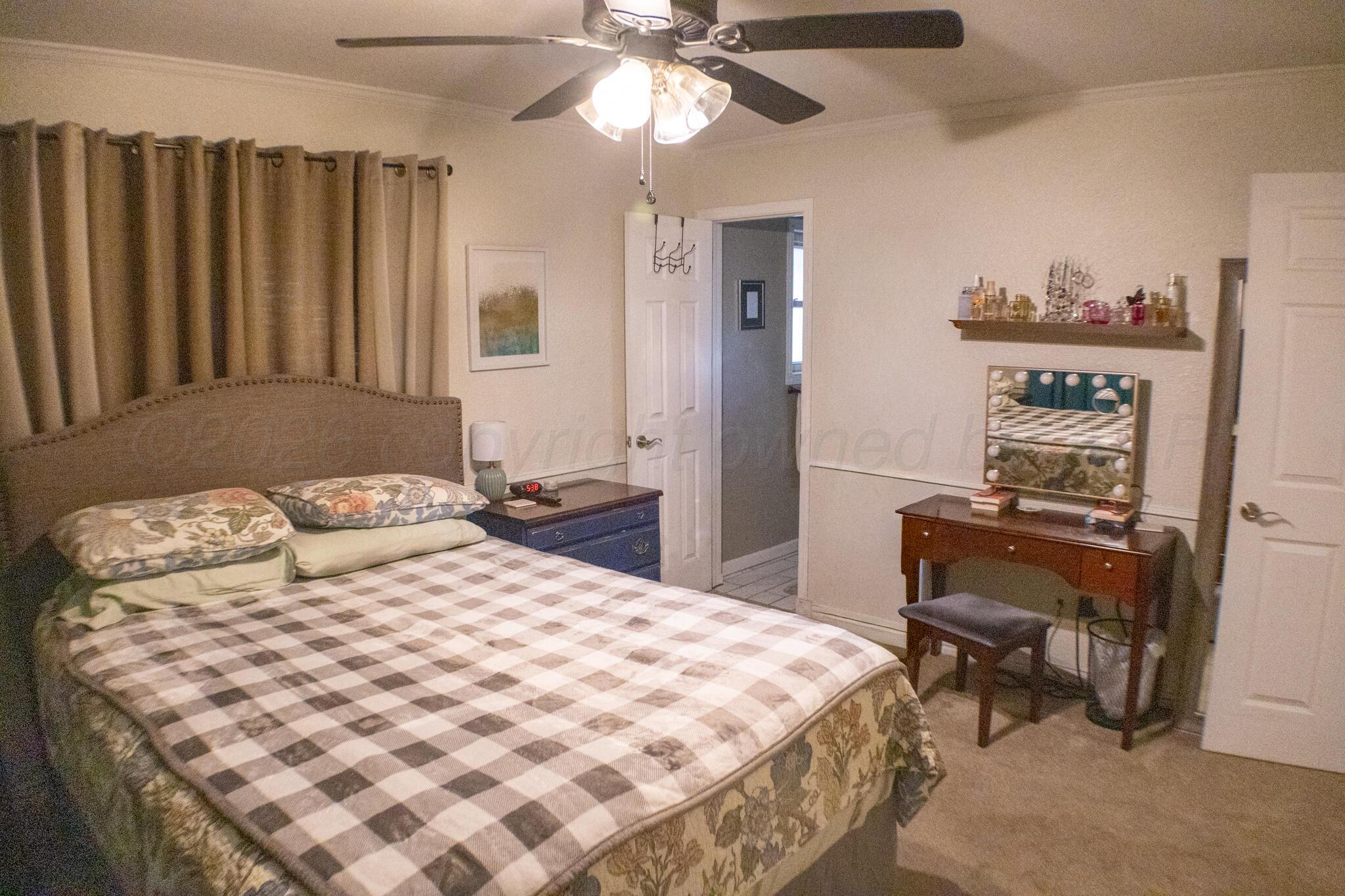 4504 Goodnight Trail Amarillo, TX 79109 - Photo 17 of 32 a bedroom with a bed and a chair