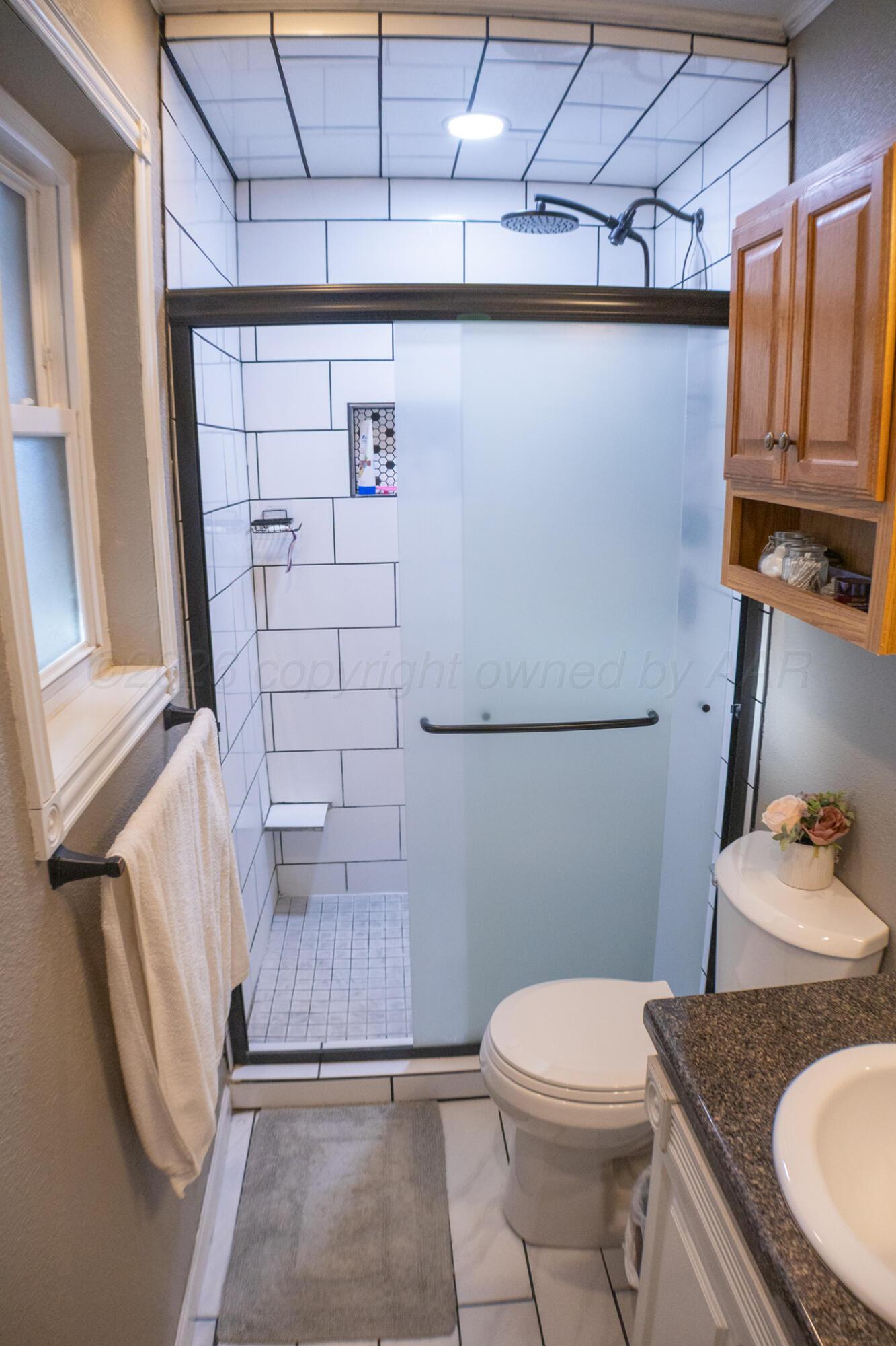 4504 Goodnight Trail Amarillo, TX 79109 - Photo 20 of 32 a bathroom with a sink toilet and shower