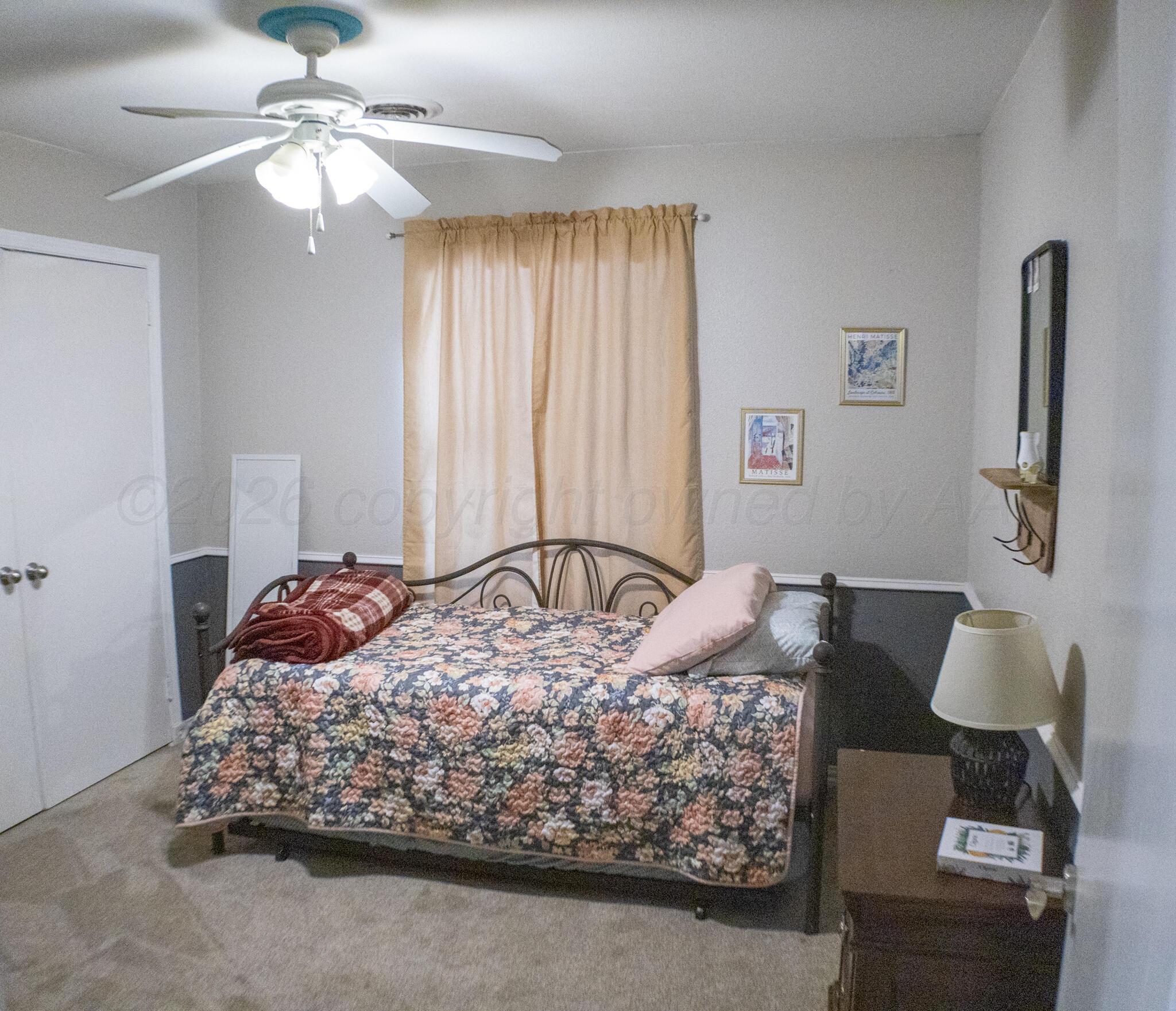 4504 Goodnight Trail Amarillo, TX 79109 - Photo 21 of 32 a bed sitting in a bedroom next to a window