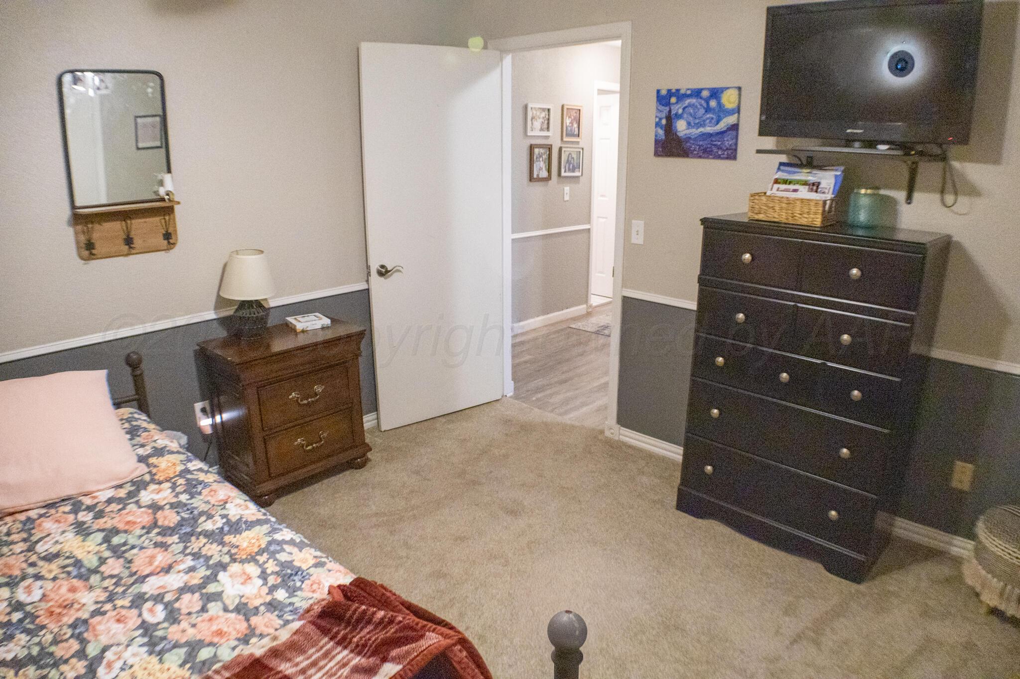 4504 Goodnight Trail Amarillo, TX 79109 - Photo 22 of 32 a room with a dresser and a mirror