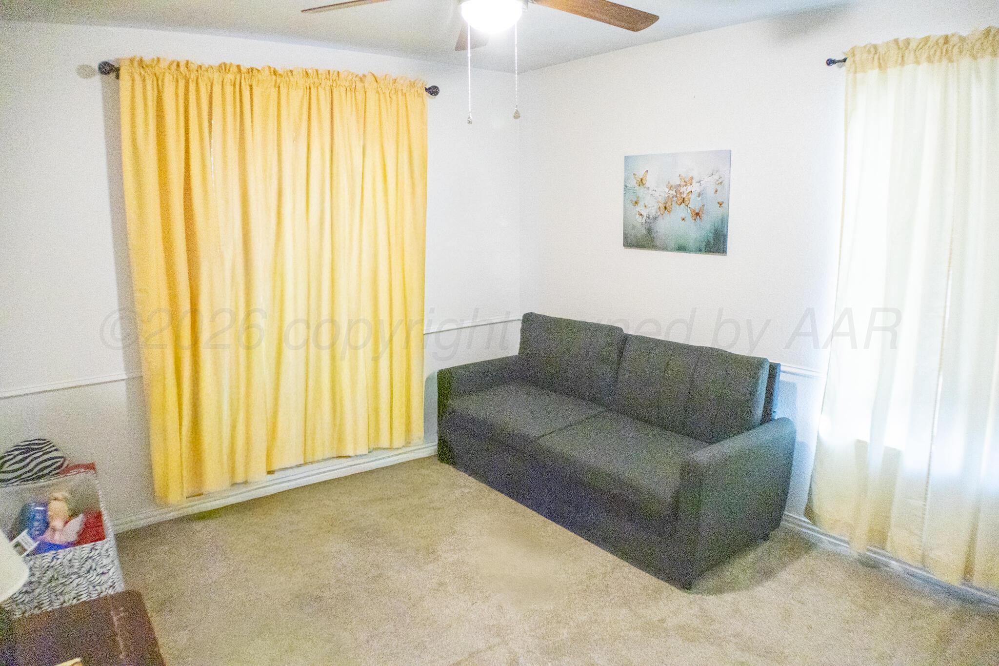 4504 Goodnight Trail Amarillo, TX 79109 - Photo 26 of 32 a living room with furniture and a window