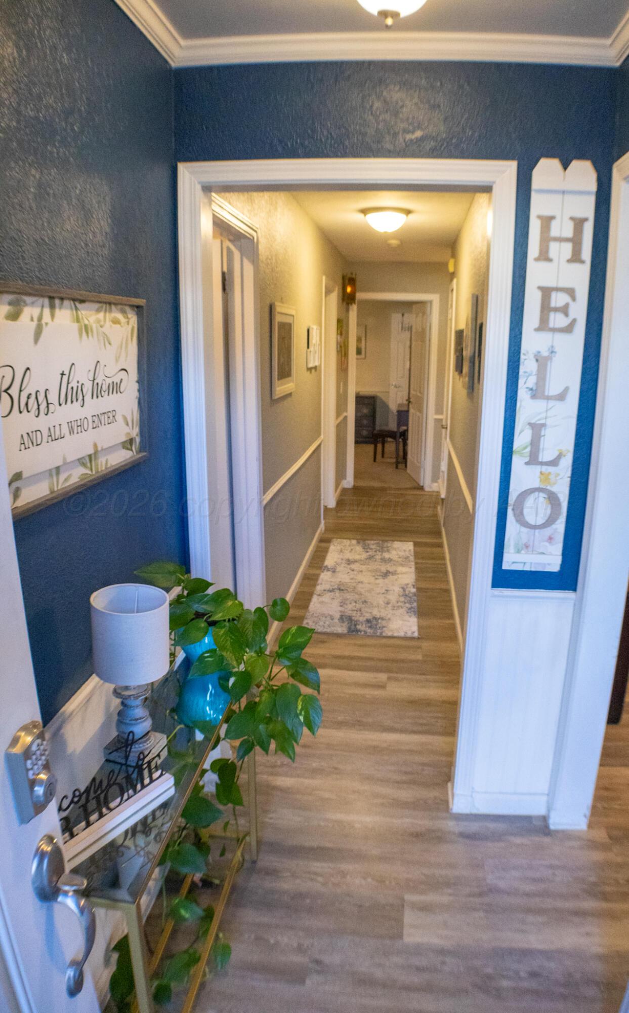 4504 Goodnight Trail Amarillo, TX 79109 - Photo 4 of 32 a hallway with wooden floor and furniture