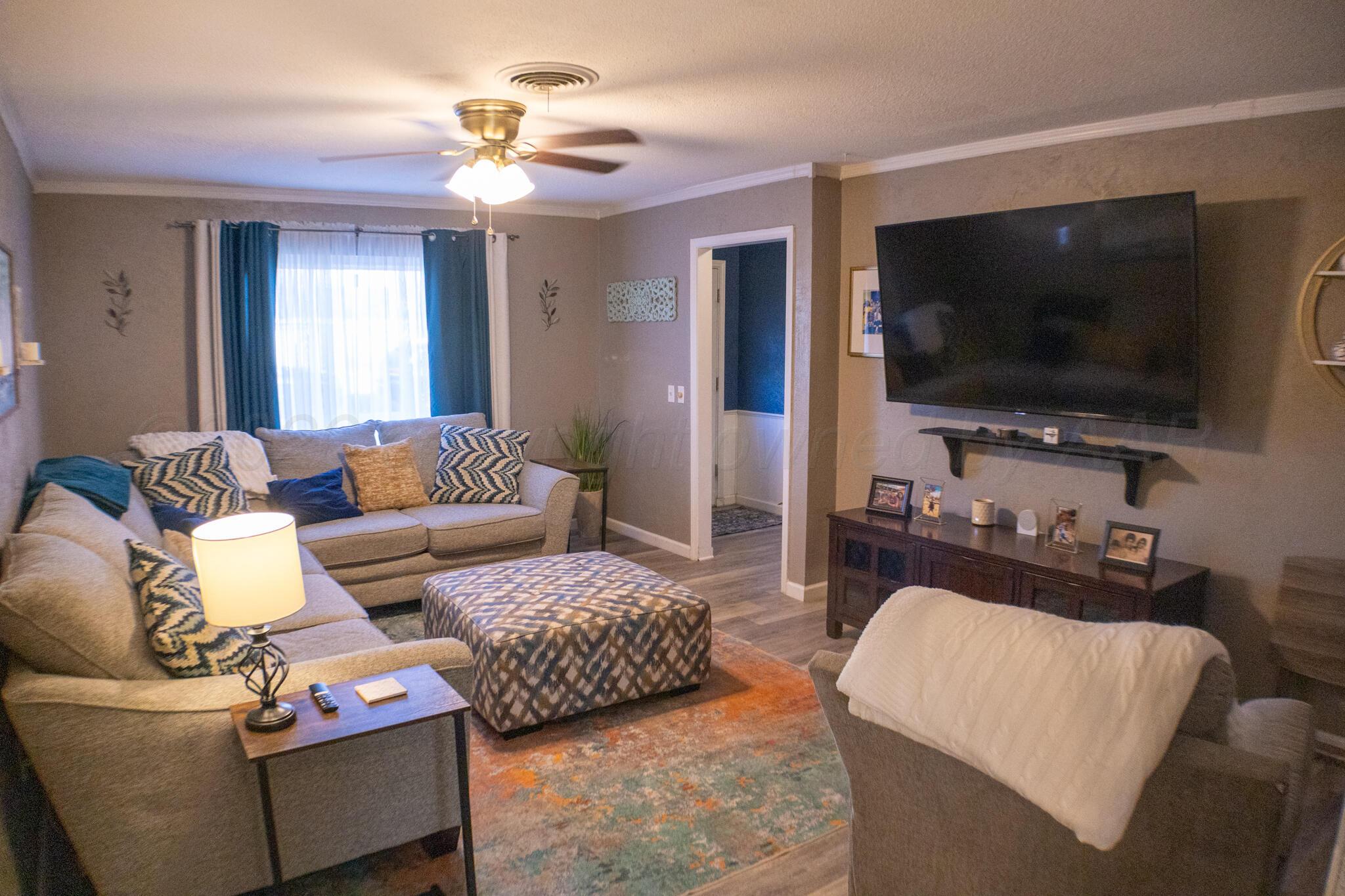 4504 Goodnight Trail Amarillo, TX 79109 - Photo 6 of 32 a living room with furniture and a flat screen tv