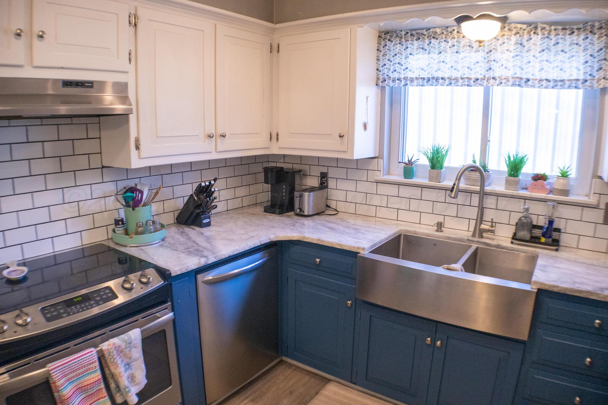 4504 Goodnight Trail Amarillo, TX 79109 - Photo 9 of 32 a kitchen with a sink stove and cabinets