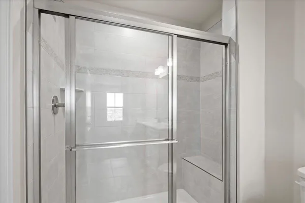 a bathroom with a glass shower door