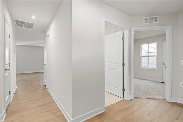 a view of a hallway with wooden floor