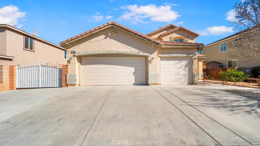 14561 Hummingbird Road Victorville, CA 92394 - Photo 1 of 1 a front view of a house with a yard and garage