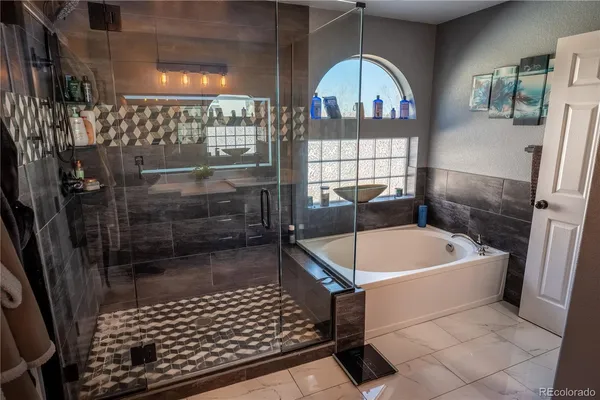 a bathroom with a bathtub and a shower