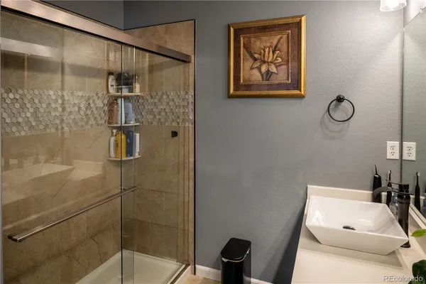 a bathroom with a shower and a sink