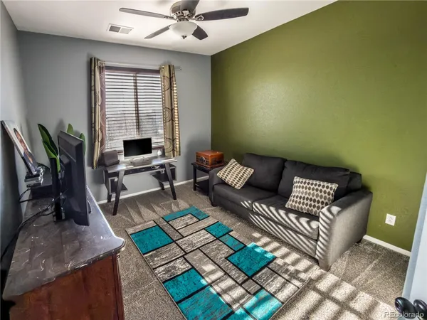 a living room with furniture and a potted plant